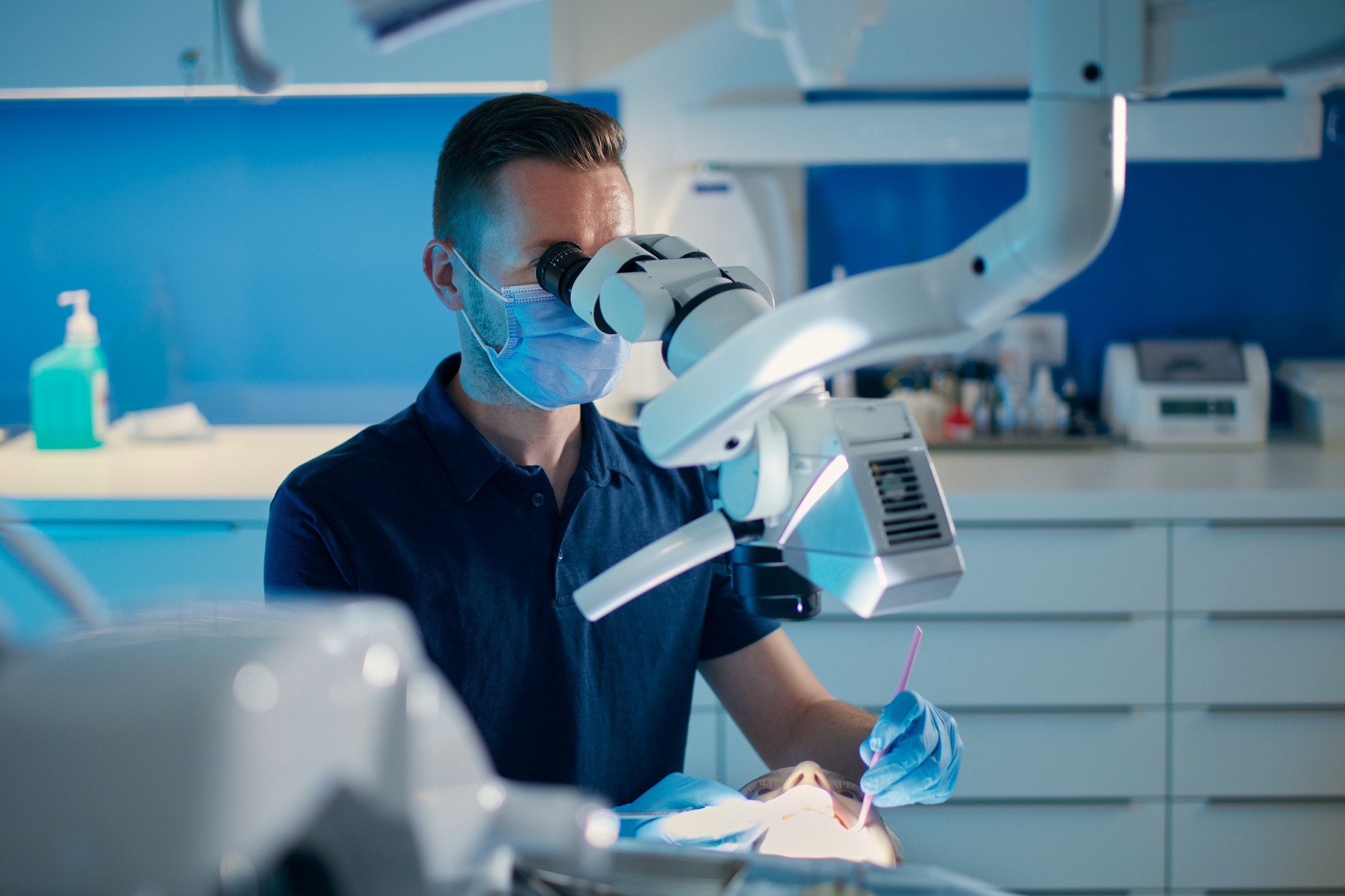 Dentist examining patient in modern dental surgery